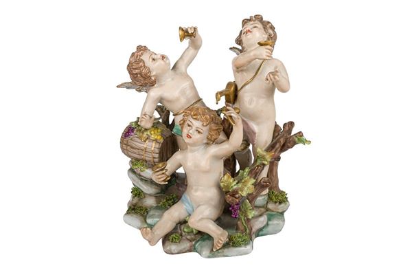 Group of putti with grapes in polychrome porcelain