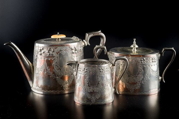 Lot of a teapot, a milk jug and a tea holder in silver metal