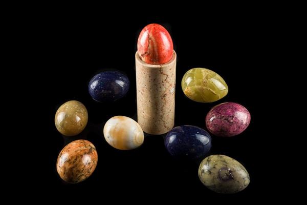 Lot of nine collectible eggs in alabaster with marble base