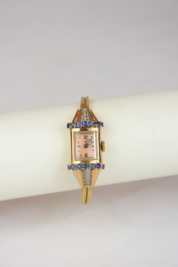 Orologio in oro giallo con diamanti e zaffiri