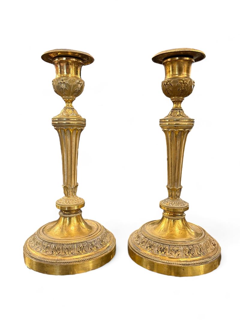 Due Coppie di candelieri in bronzo dorato