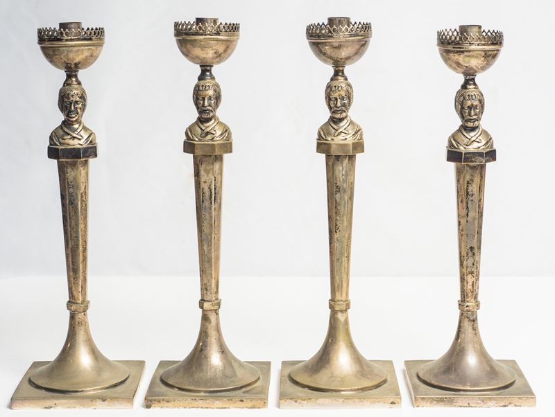 Serie di quattro candelieri in argento