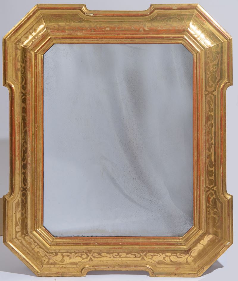 Grande specchiera a guantiera sagomata, legno dorato, decorazioni a bulino a motivi fogliacei (XI...