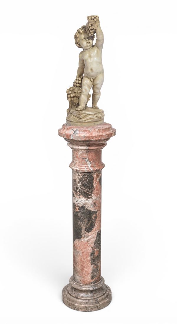 Colonna in marmo rosso con putto con acini d'uva 