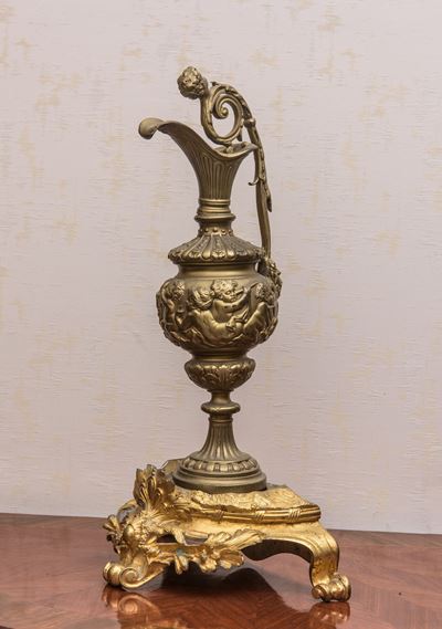 Versatoio in metallo dorato con putti e base rocaille in bronzo dorato
