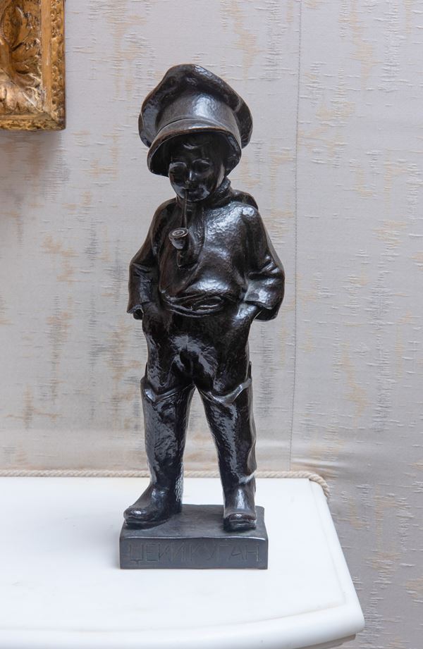 Scultura in bronzo raffigurante bambino con pipa