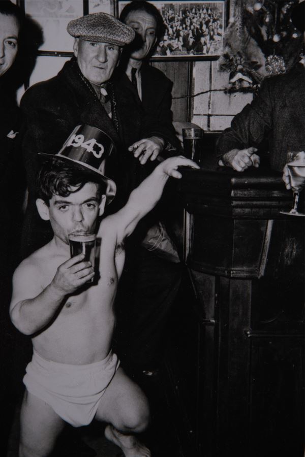 Weegee - Shorty, the Bowery Cherub, New Year’s Eve at Sammy’s Bar, New York