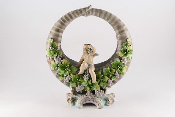 Basket centerpiece with polychrome pig putto